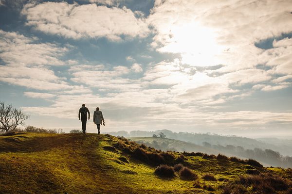 The North Downs Way through Wye and Kings Wood in the Kent Downs National Landscape features scenic trails amidst ancient woodlands. The path offers lush greenery, diverse wildflowers, and tranquil views of rolling hills, showcasing the natural beauty of the Kent Downs.